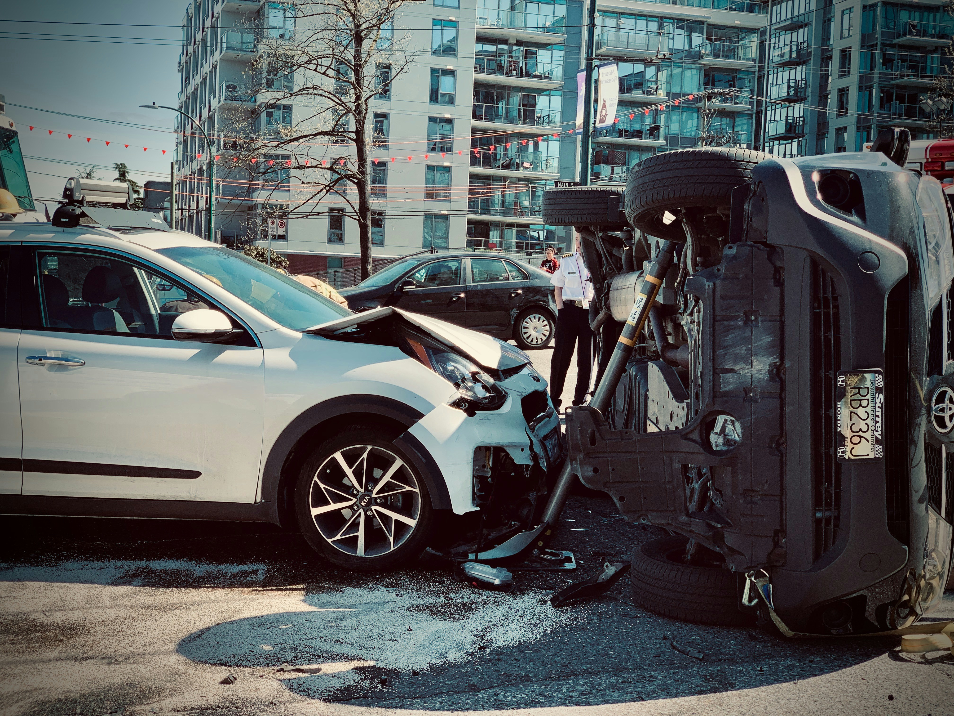 Car crash scene with an overturned vehicle and front-end damage